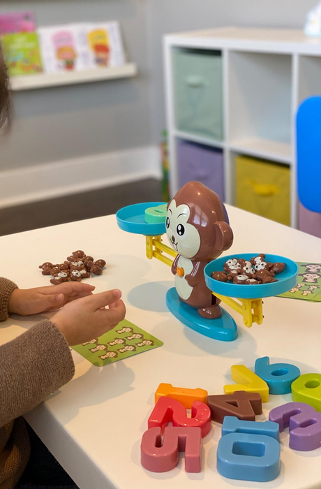 A child enjoying a game, actively playing and learning.