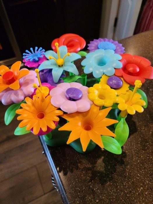 A reviewer's photo of colorful plastic flower toys