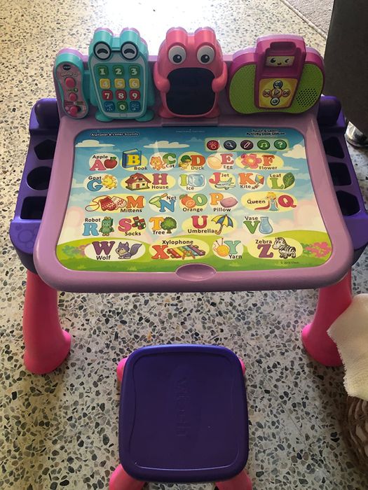 An activity desk with a stool designed for young children.