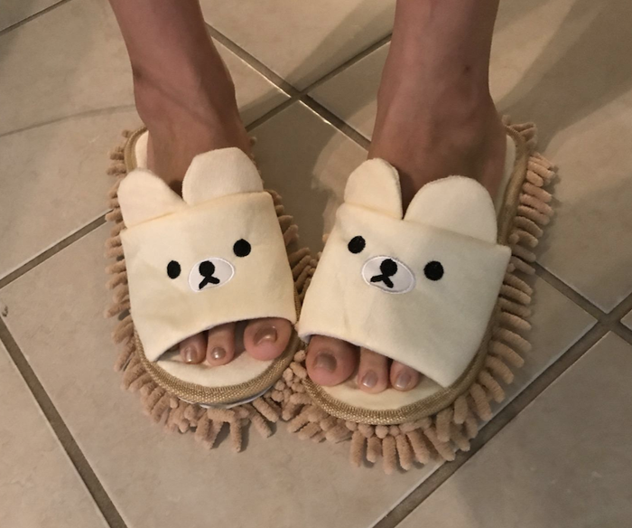 Reviewer showcasing the mop slippers in use