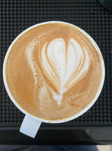A reviewer's photo showcasing heart-shaped latte art inside their Ember mug.