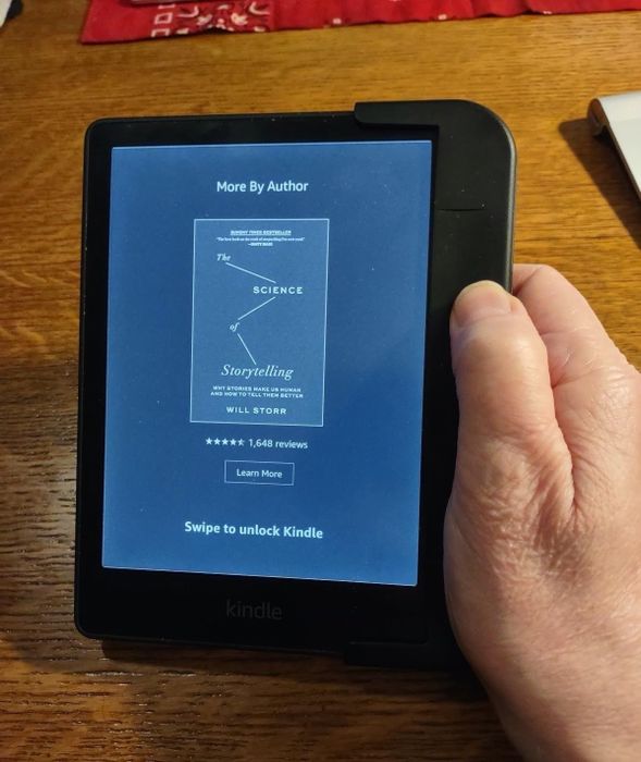 Photo of the reviewer holding the Kindle