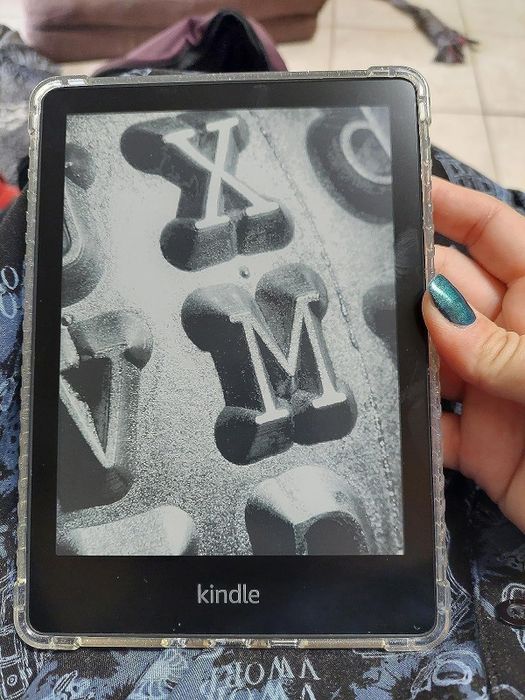 Another photo of the reviewer holding the Kindle