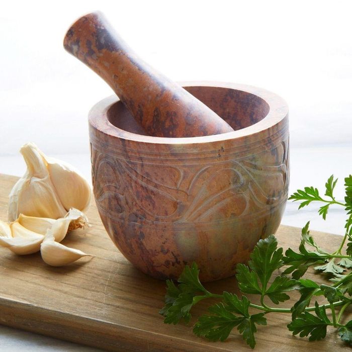 The mortar and pestle set is displayed, showcasing its sturdy and elegant design.