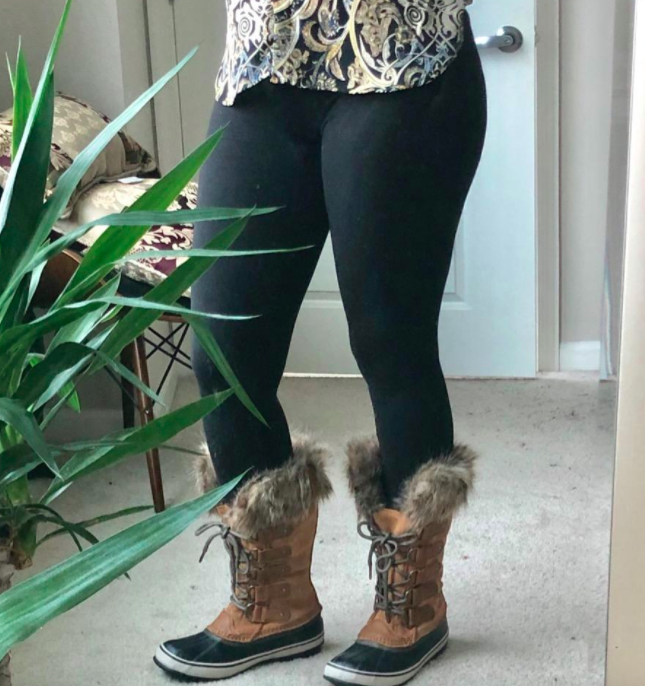 A reviewer modeling the fleece-lined leggings paired with winter boots.