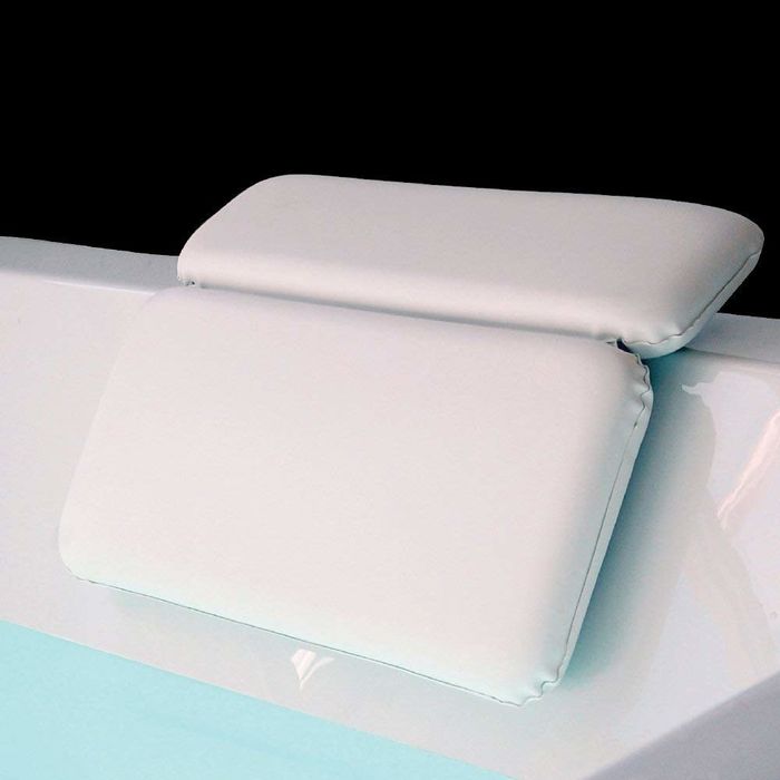 cushioned pillow resting over the side of the tub