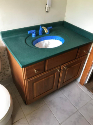 photo showing an unattractive green bathroom vanity top