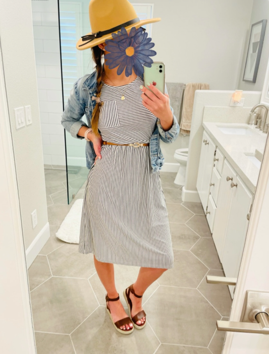 Reviewer shows the dress with white and blue vertical stripes, paired with a denim jacket and sandals.