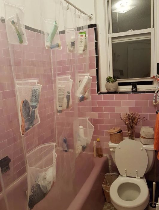 Photo of the shower curtain with pockets holding various toiletries