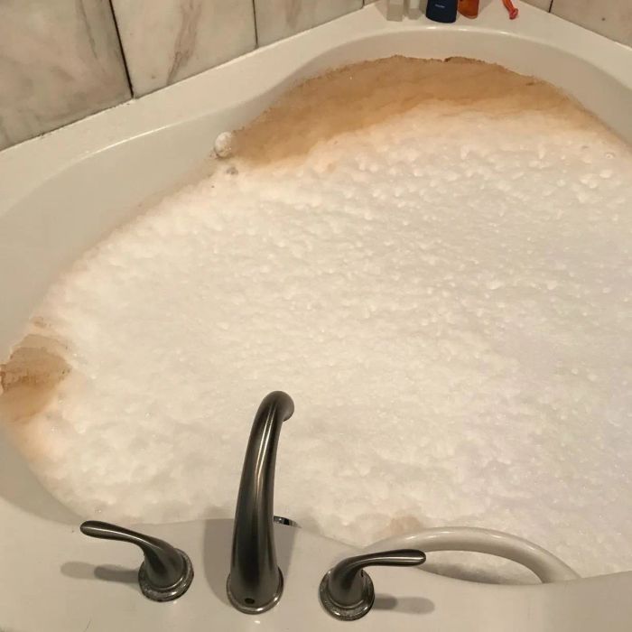 Photo of a reviewer’s jetted tub releasing brown, dirty water during cleaning