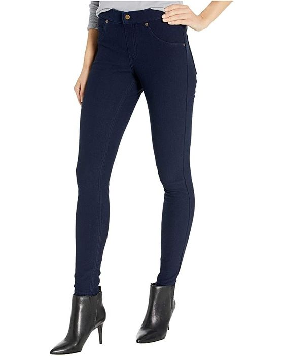 The lower half of the model is wearing dark blue jeggings.