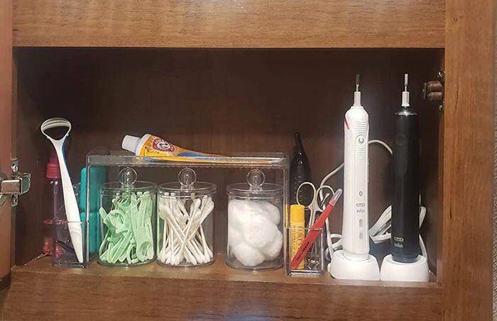 A white plastic organizer neatly holding toiletries
