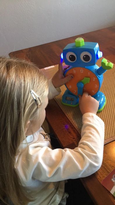 A child enjoying playtime with the Tock Learning Clock