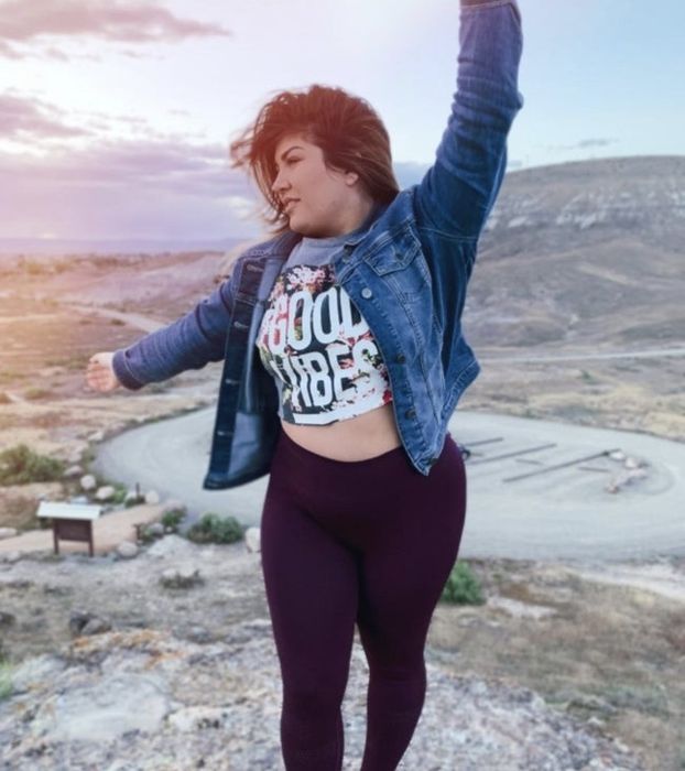 A reviewer is seen rocking a denim jacket paired with purple leggings.