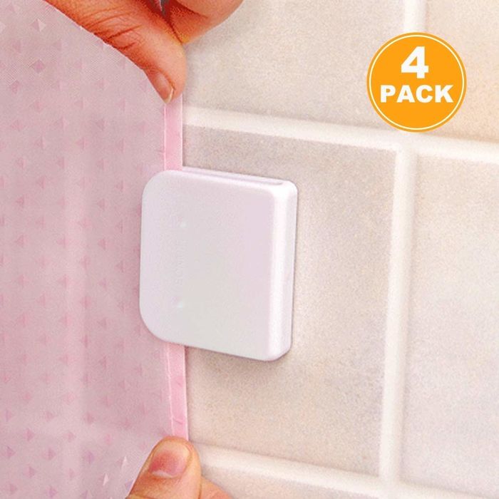 shower curtain being securely placed into plastic holder mounted on the wall