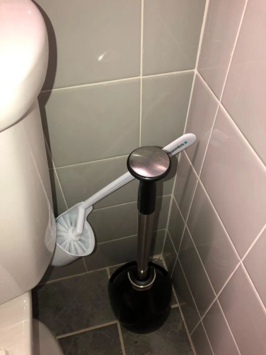 The toilet brush is angled outward for easy access.