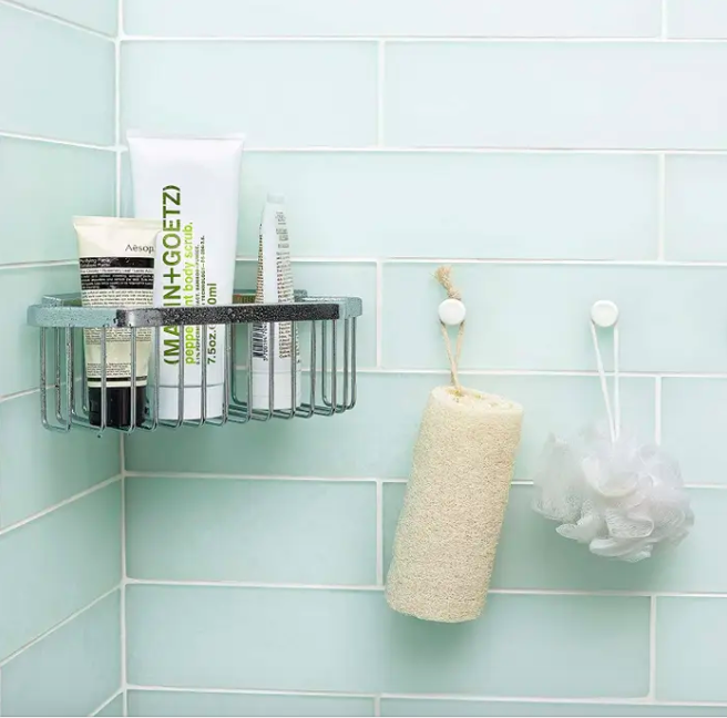 A shot inside a shower with a mounted shower caddy attached to the wall.