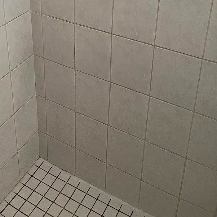 The same reviewer showcasing a pristine shower wall after applying the product
