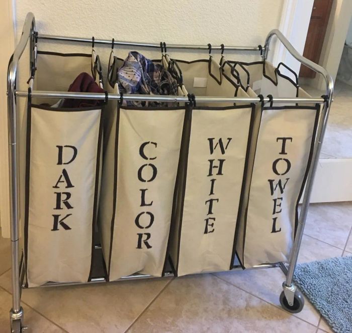 reviewer photo of a laundry organizer stenciled with labels: dark, color, white, and towel