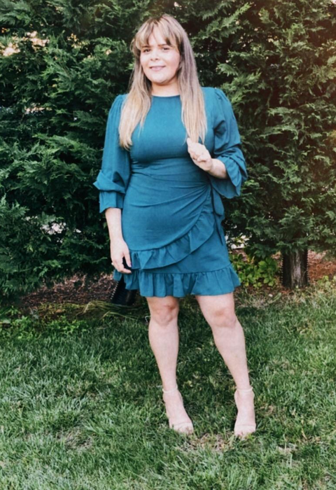 Reviewer in a dark blue dress