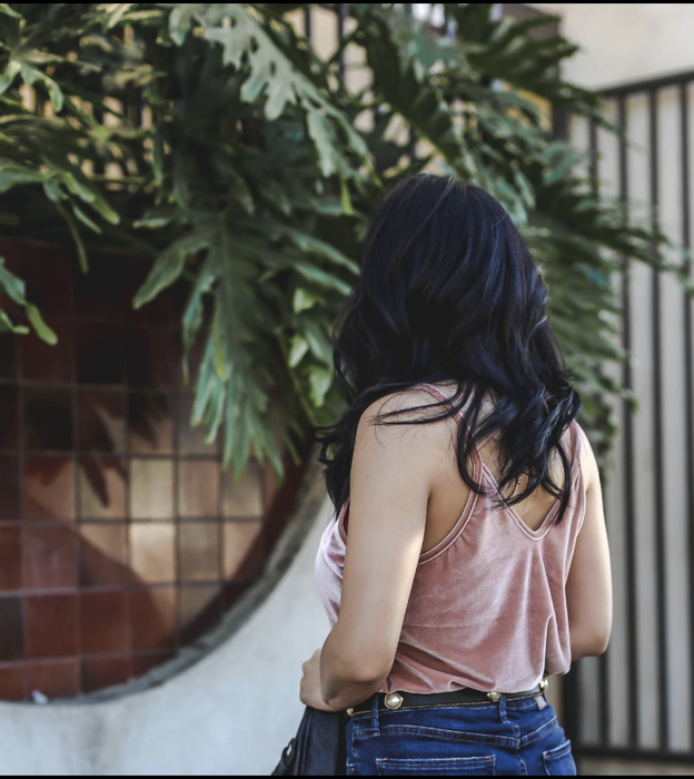 The reviewer turns around to show off the dipped V-shaped neckline at the back.