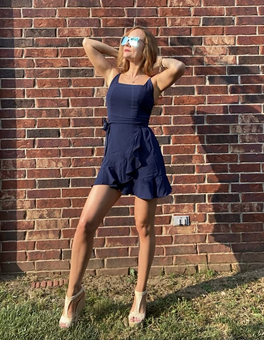 The reviewer wears the dress in a classic navy blue shade, exuding sophistication and charm.