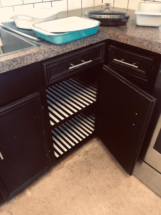 reviewer's cabinets lined with a chic black and white striped liner