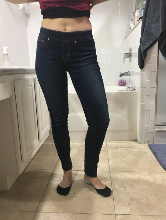 A reviewer in medium wash denim skinny jeans.
