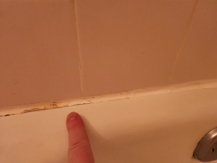 A detailed close-up of freshly cleaned grout in a shower after applying the grout whitener