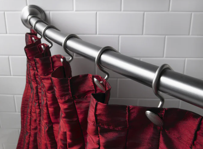 Close-up of a wall-mounted curved shower curtain rod