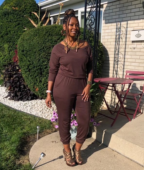 A reviewer wearing the brown jumpsuit, looking chic and effortlessly comfortable.