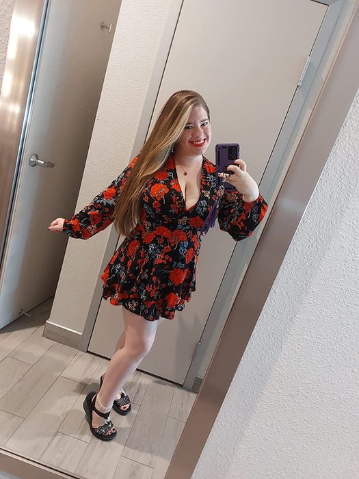 A reviewer wearing the same romper but in a striking black and red floral print for a bold twist.