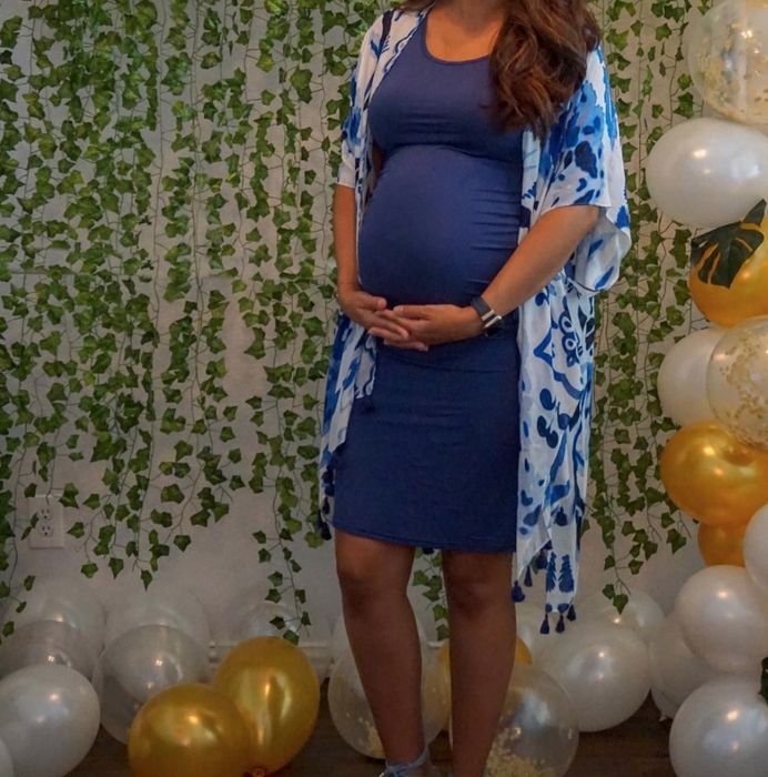 A reviewer showcasing a beautiful blue and white patterned kimono worn over a blue dress, effortlessly blending comfort and style.