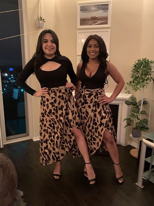 Two reviewers wearing a leopard print wrap skirt paired with black tops