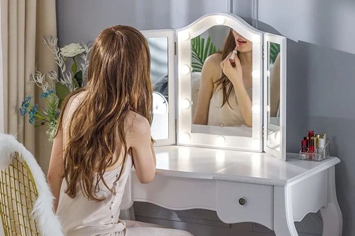 A model sitting comfortably in front of the vanity mirror