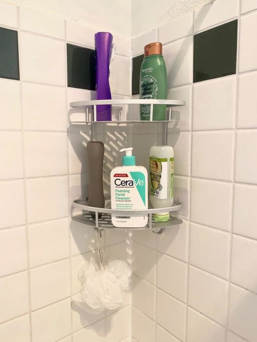 A reviewer's photo of a shelf holding toiletries and a loofah.