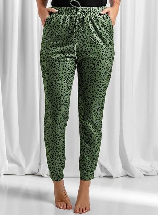 A model rocking the green leopard-print joggers.