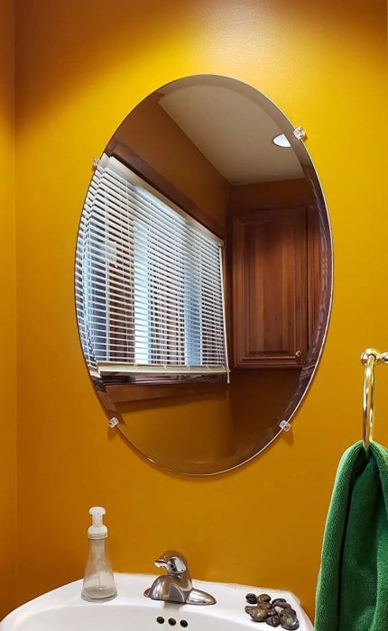 A reviewer's image showing an oval mirror in use.