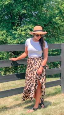Another reviewer styling the skirt with a simple white T-shirt, black sandals, and a straw hat