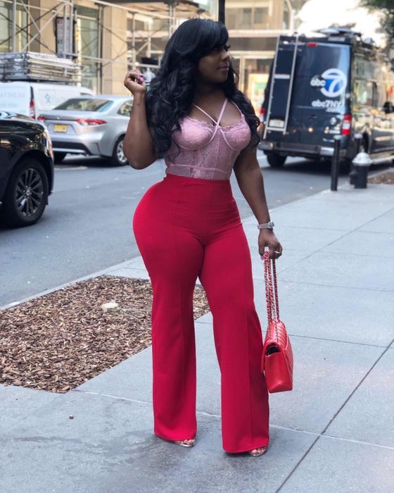 Reviewer wearing the red pants with a lace bustier top