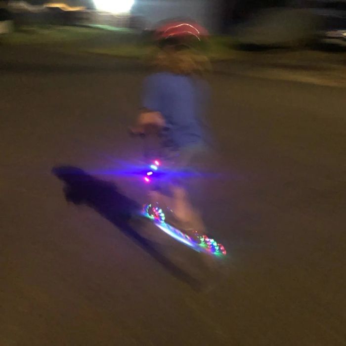 A child enjoying the illuminated scooter ride