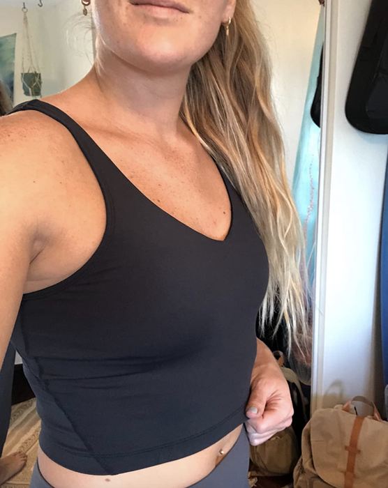 A reviewer showcasing the black tank top.