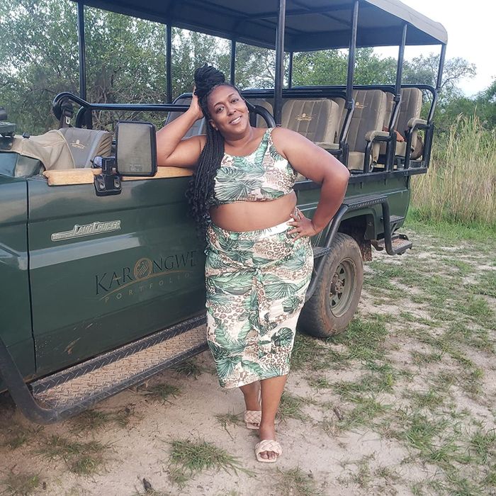 Reviewer wearing a green and brown jungle skirt set during a safari ride