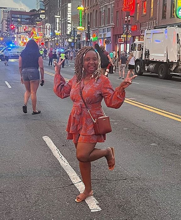 A reviewer spotted on the street wearing a red and purple patterned long sleeve romper, creating a vibrant and stylish look.