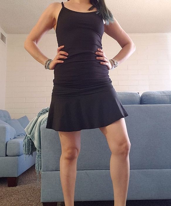 A reviewer rocking a black ruched mini skirt for a trendy and edgy outfit.