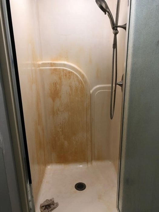 The same shower after a quick spray of Iron Out, with significantly less rust visible.