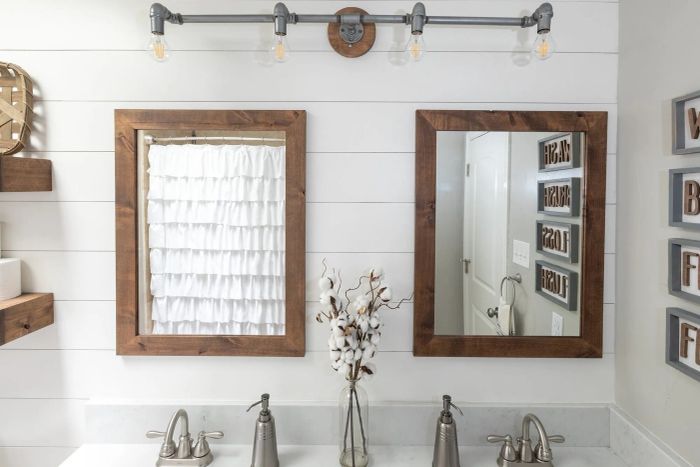 Two brown vanity mirrors placed in the bathroom