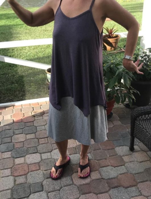 A reviewer rocking the sleeveless gray flowy tunic, offering both comfort and style.