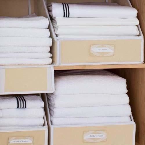 A close-up view of the bins storing towels and sheets, neatly arranged.