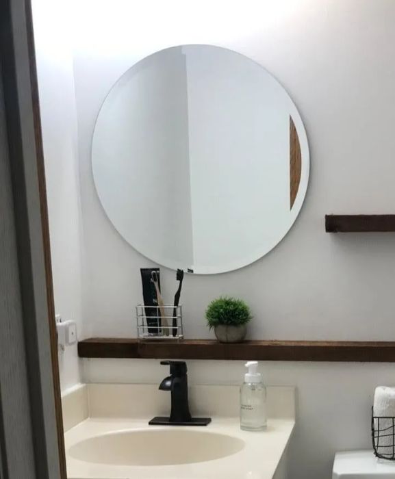 A reviewer's image featuring a round mirror in their space.